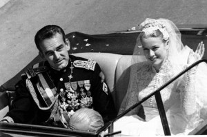** FILE ** Princess Grace Kelly waves to cheering crowds lining the road as she rides in an open car with Prince Rainier III following their marriage in a religious wedding ceremony in the Monaco Cathedral, in this April 19, 1956 file photo. Many see Rainier's ailing health as the final chapter of a fairy tale romance between an American movie queen and a European prince Friday which has captivated the world , Friday, March 25, 2005 and whose mystique has endured the two decades since her tragic death. (AP Photo)